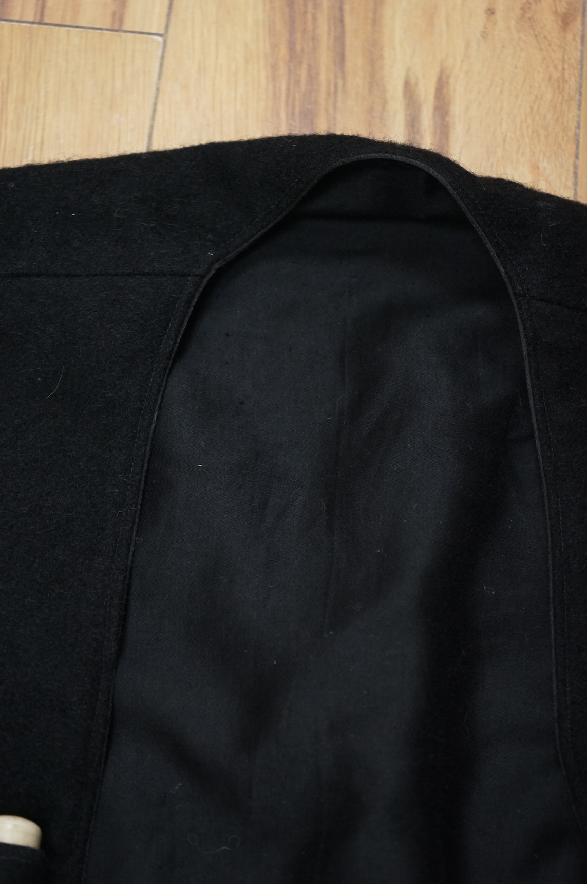 A theatrical gents black wool coat, with unusual pocket detail. 120cm long